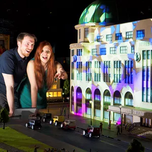 A couple looks together at the replica of the Haus Vaterland in Little BIG City