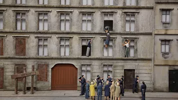 Miniature reconstruction of a woman throwing herself out the window to escape to West Berlin at Little BIG City Berlin